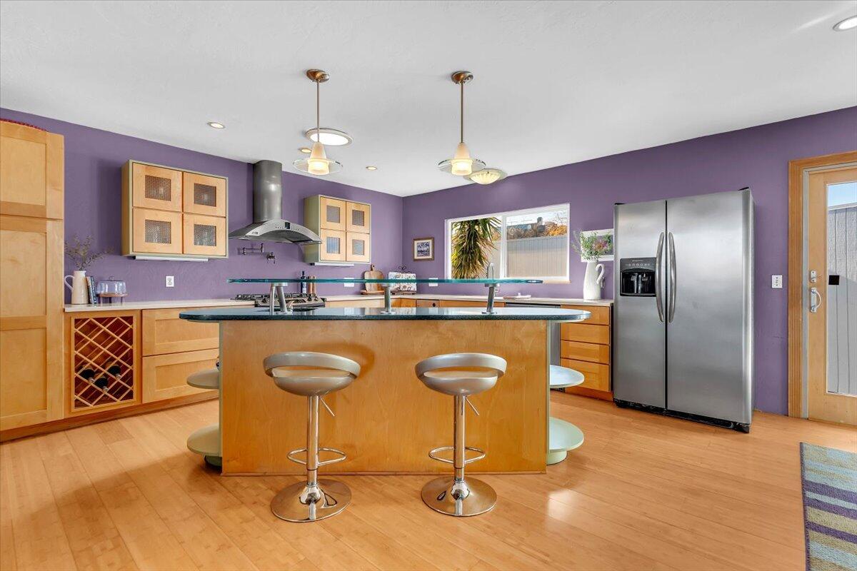 846 Rio Street Red Bluff, CA 96080 - Photo 7 of 73 a kitchen with stainless steel appliances granite countertop a refrigerator a sink dishwasher a stove and a dining table with wooden floor