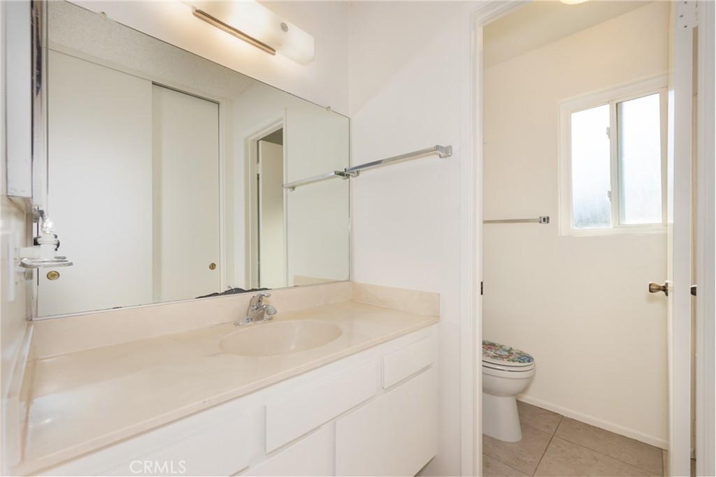 365 Midori Lane Calimesa, CA 92320 - Photo 14 of 26 a bathroom with a granite countertop sink a toilet and shower