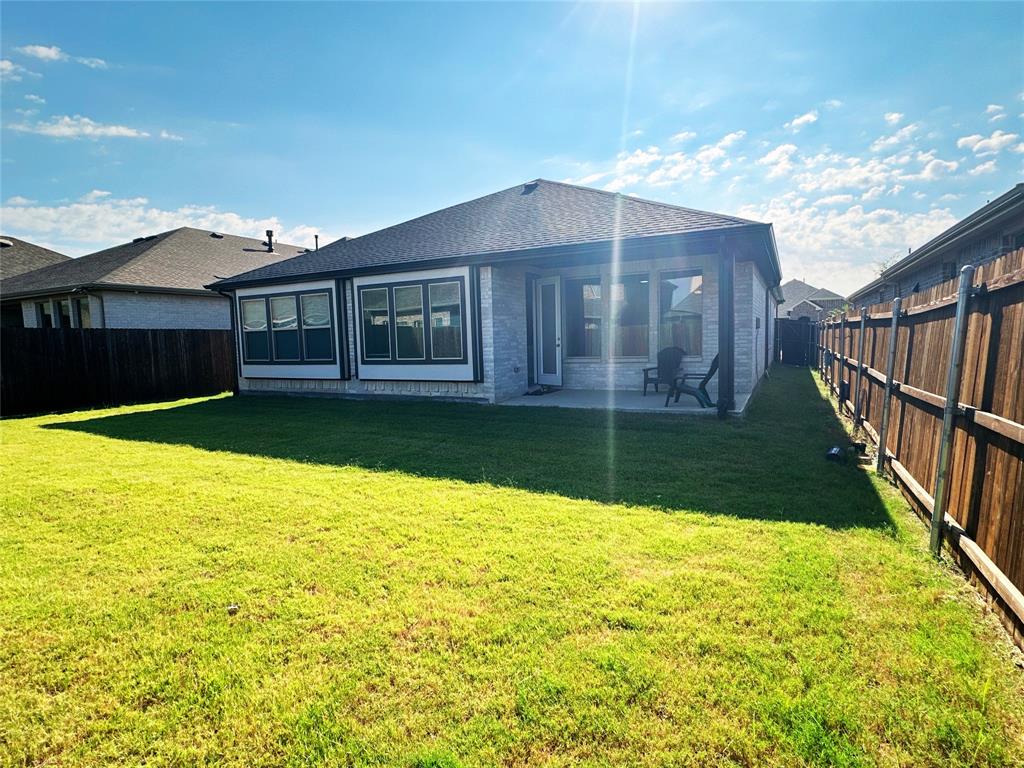1304 Caprock Drive Forney, TX 75126 - Photo 13 of 15 Rear view of property featuring a patio, a fenced backyard, and a shingled roof