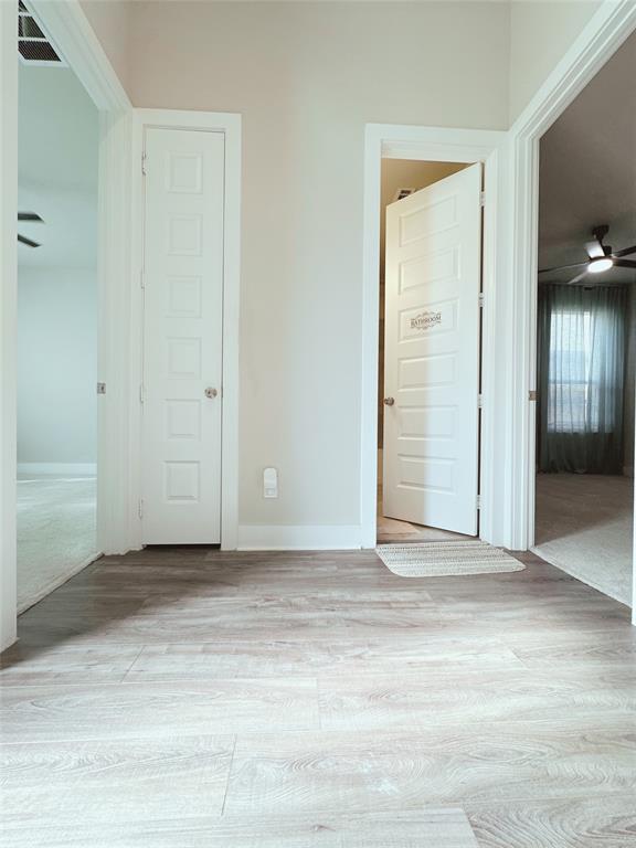 1304 Caprock Drive Forney, TX 75126 - Photo 3 of 15 Unfurnished bedroom with light wood-style flooring and baseboards