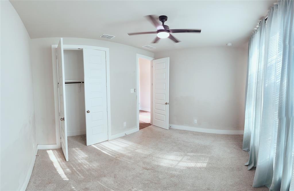 1304 Caprock Drive Forney, TX 75126 - Photo 4 of 15 Unfurnished bedroom featuring light colored carpet, ceiling fan, and a closet