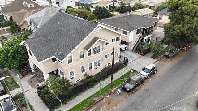 an aerial view of multiple houses with yard