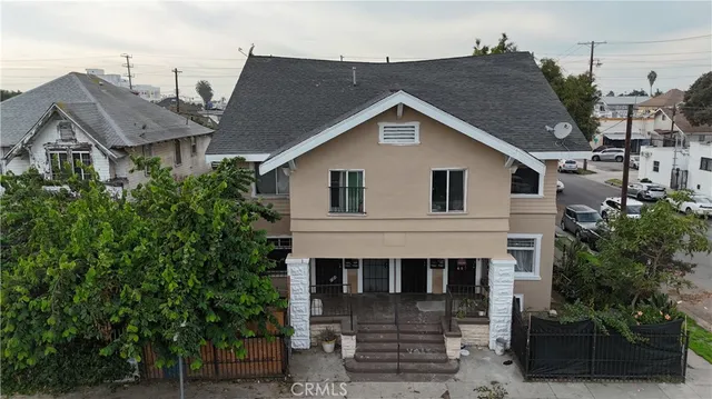 a view of a house with a yard and plants