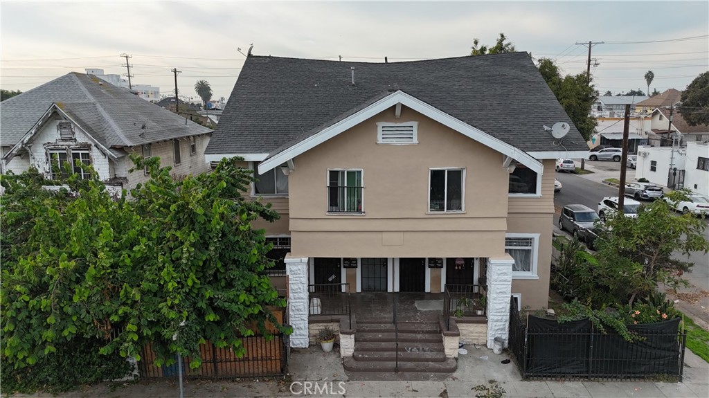 4301 Woodlawn Avenue Los Angeles, CA 90011 - Photo 3 of 8 a view of a house with a yard and plants