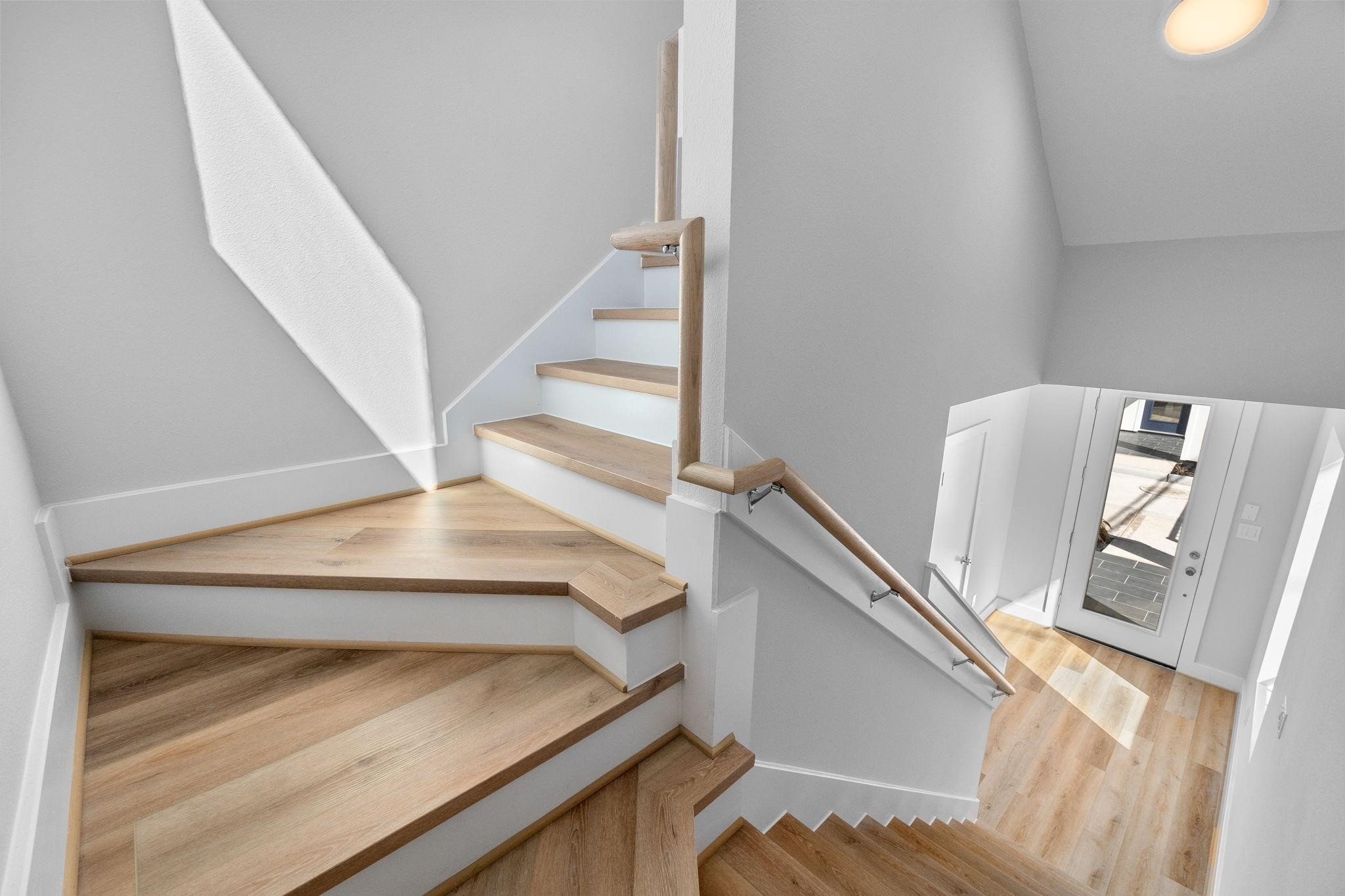 903 Quitman Street, Unit B Houston, TX 77009 - Photo 20 of 24 Modern staircase with wood treads, clean railing lines, and open design, adding architectural interest to the home.