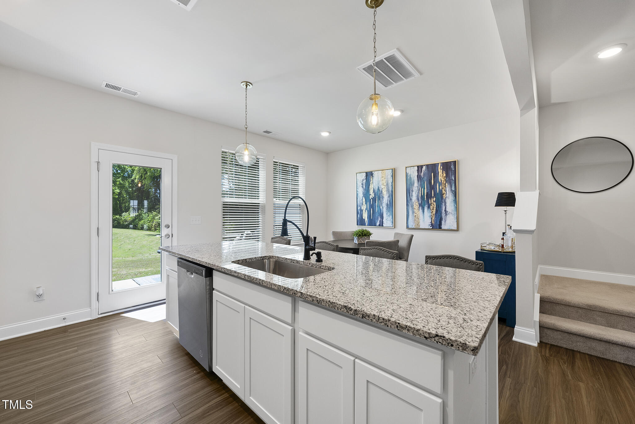 93 Begonia Street Angier, NC 27501 - Photo 12 of 29 a kitchen with center island wooden floor and a large window