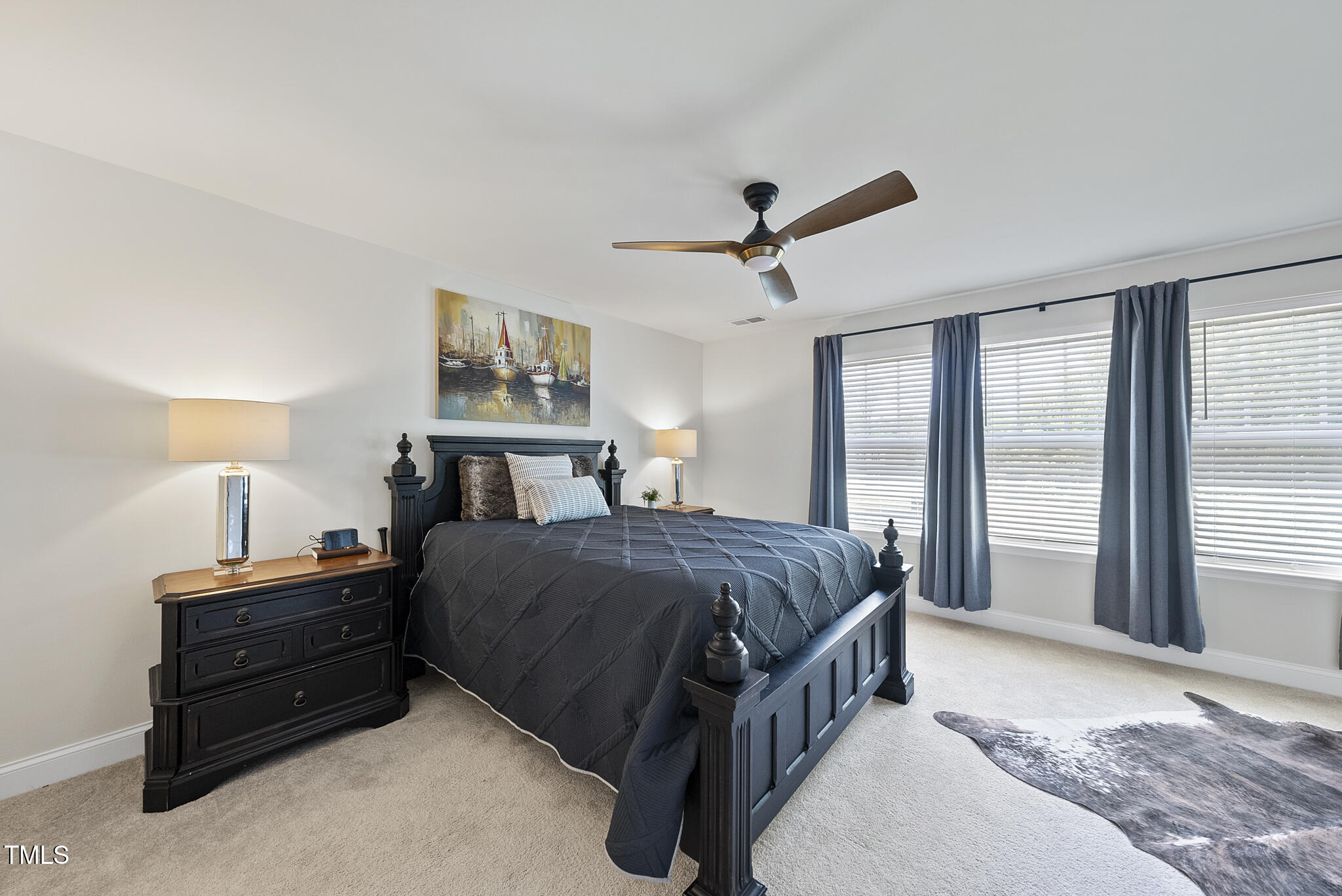 93 Begonia Street Angier, NC 27501 - Photo 19 of 29 a spacious bedroom with a bed a large window and a chandelier