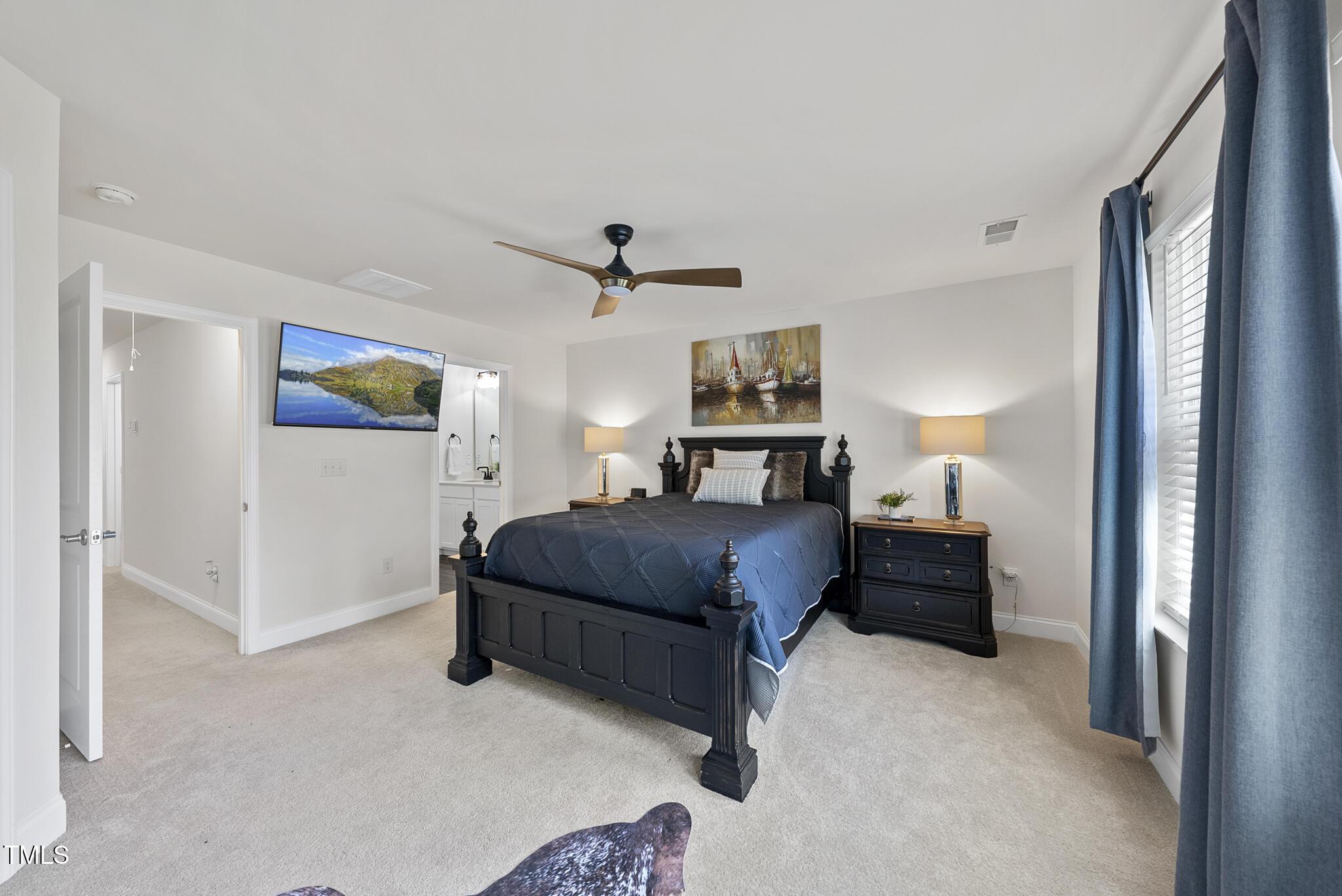 93 Begonia Street Angier, NC 27501 - Photo 21 of 29 a spacious bedroom with a bed and a cabinets