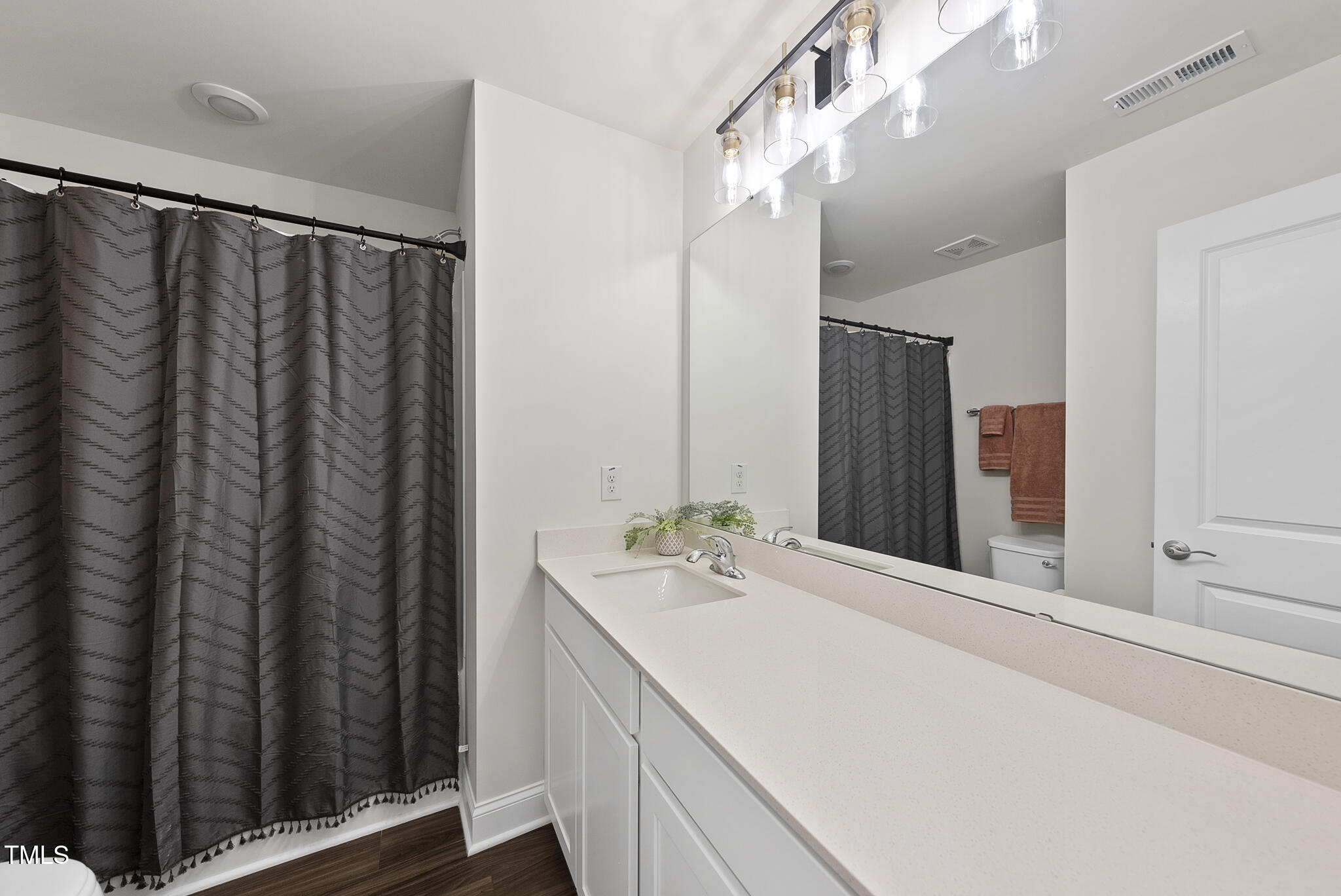 93 Begonia Street Angier, NC 27501 - Photo 25 of 29 a bathroom with a double vanity sink and a mirror