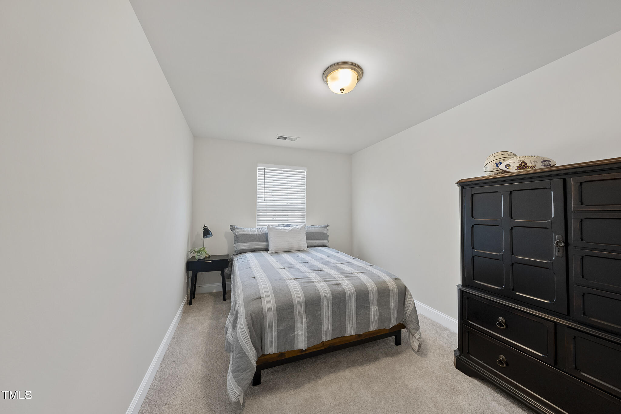 93 Begonia Street Angier, NC 27501 - Photo 26 of 29 a bedroom with a bed and a closet