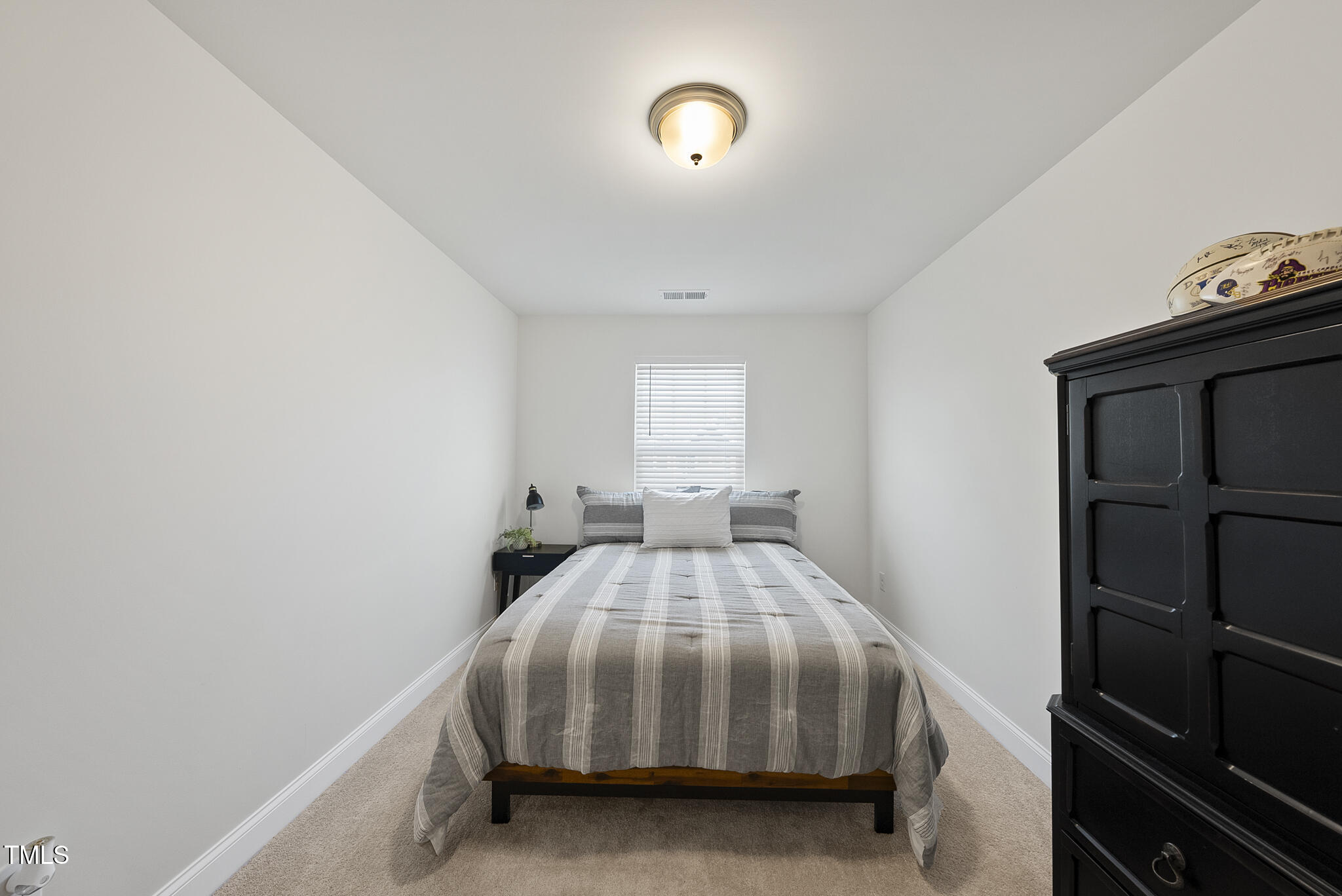 93 Begonia Street Angier, NC 27501 - Photo 27 of 29 a bedroom with a bed and a window
