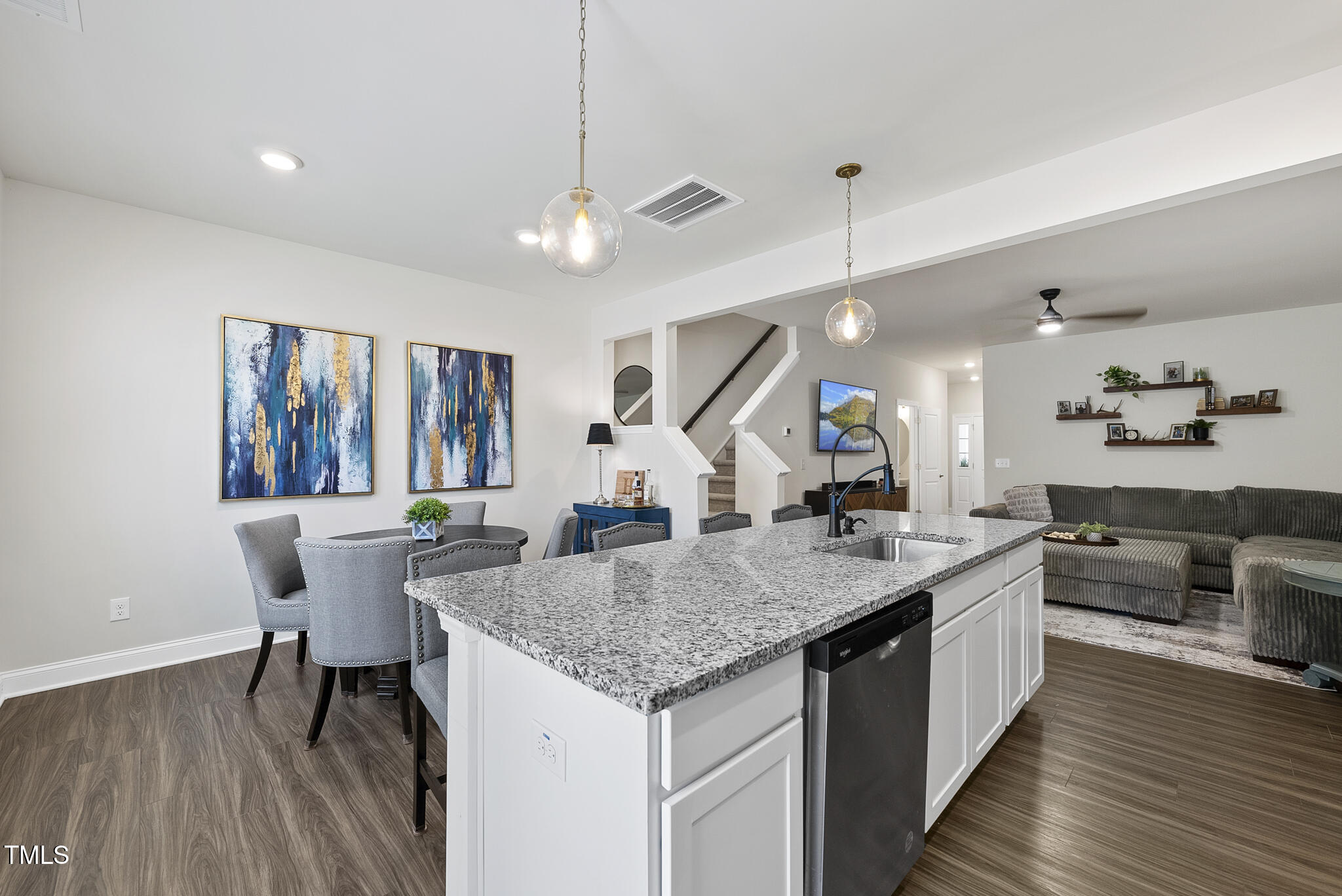 93 Begonia Street Angier, NC 27501 - Photo 9 of 29 a kitchen with granite countertop center island wooden floor and stainless steel appliances