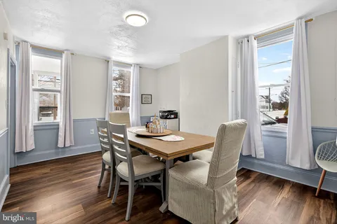 a view of a dining room with furniture and wooden floor