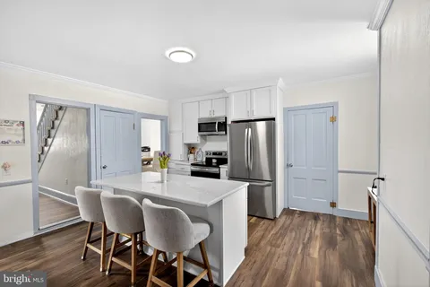 a kitchen with stainless steel appliances a refrigerator and a stove top oven