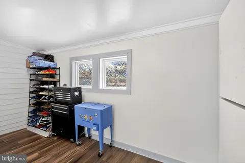 a view of a workspace with furniture and wooden floor