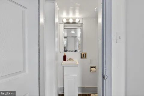 a bathroom with a sink mirror and vanity