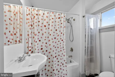 a bedroom with bed and glass door