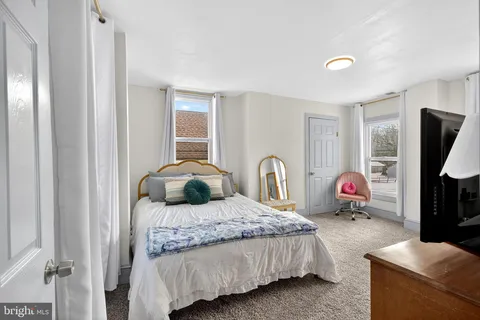 a bedroom with a bed and flat screen tv