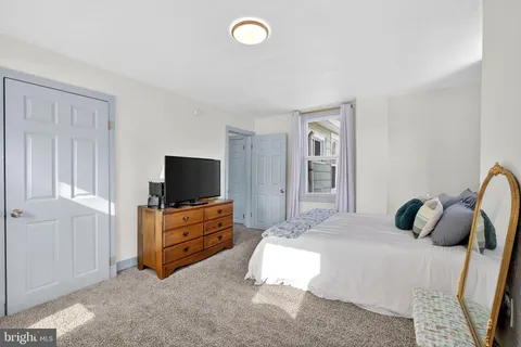 a bedroom with bed and window