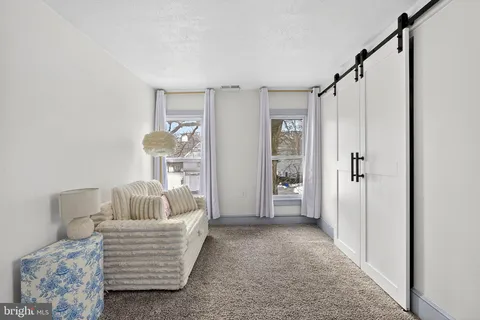 a view of a livingroom with a tub and shower