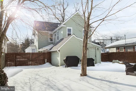 a view of a house with yard and sitting area