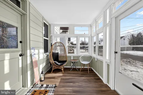 a view of a dining room with furniture wooden floor and next to a window