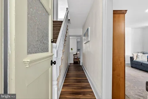 a view of a hallway with a livingroom and a furniture