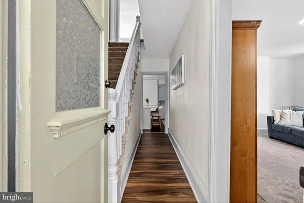 a view of a hallway with a livingroom and a furniture