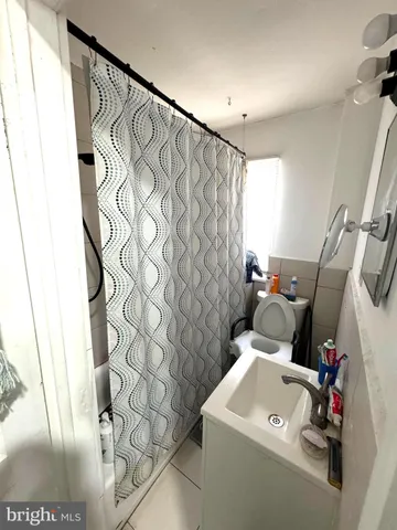 a bathroom with a toilet and a shower curtain