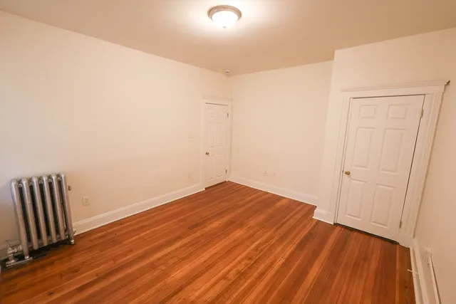 a view of room with wooden floor