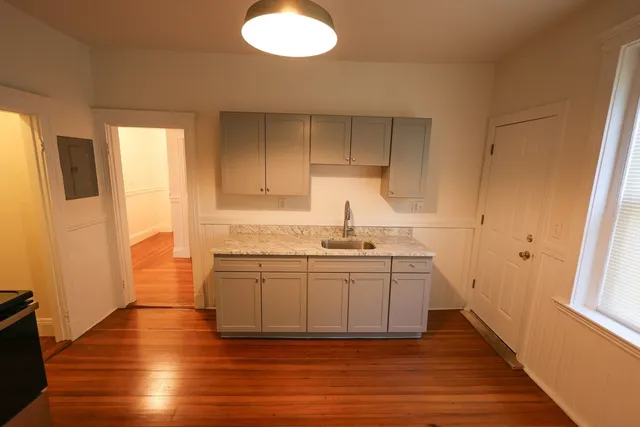 a kitchen with stainless steel appliances granite countertop a sink a stove a refrigerator and cabinets