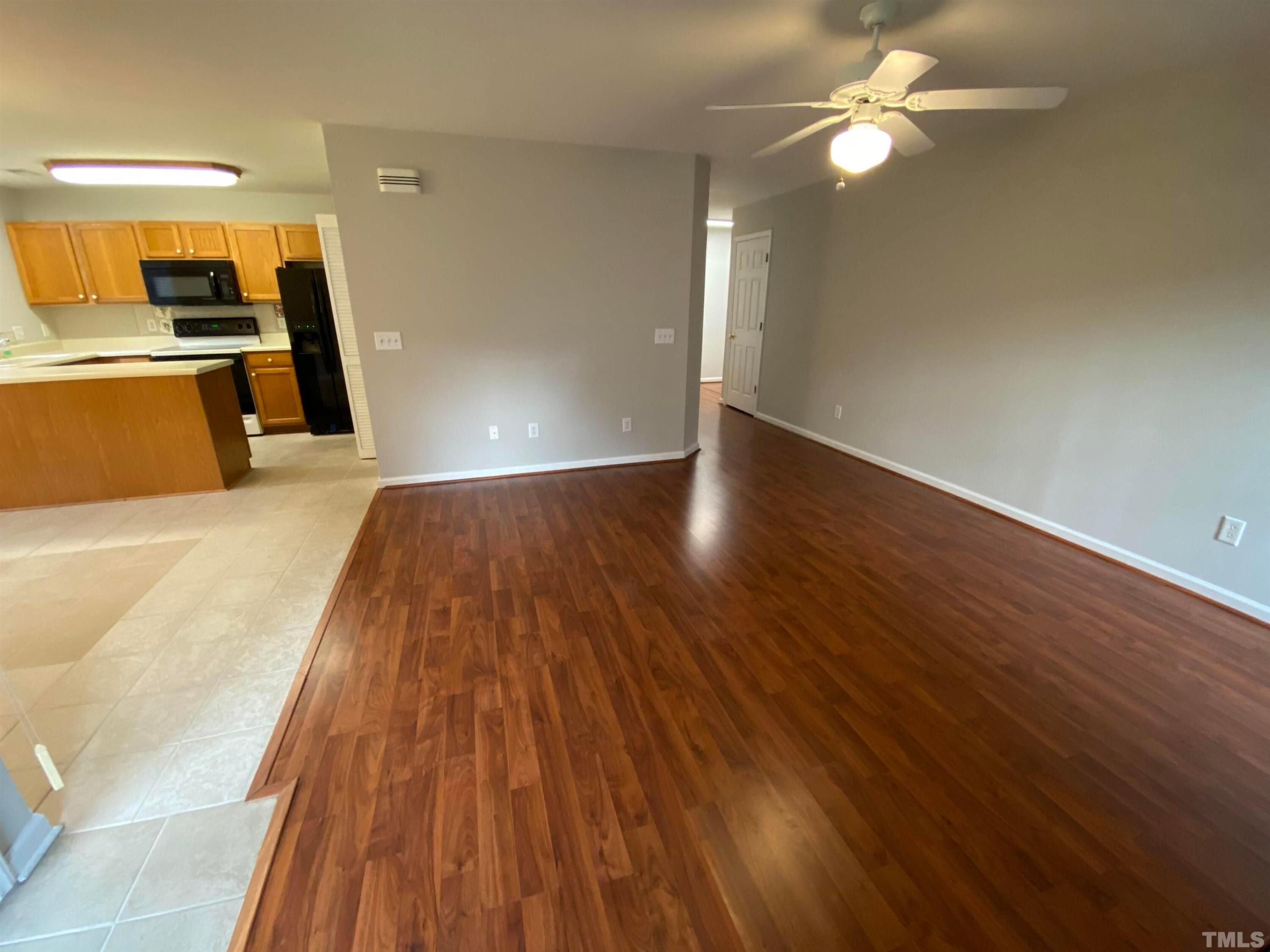 2413 Wellington Ridge Loop, Unit 2413 Cary, NC 27518 - Photo 8 of 30 a view of a room with wooden floor and a ceiling fan