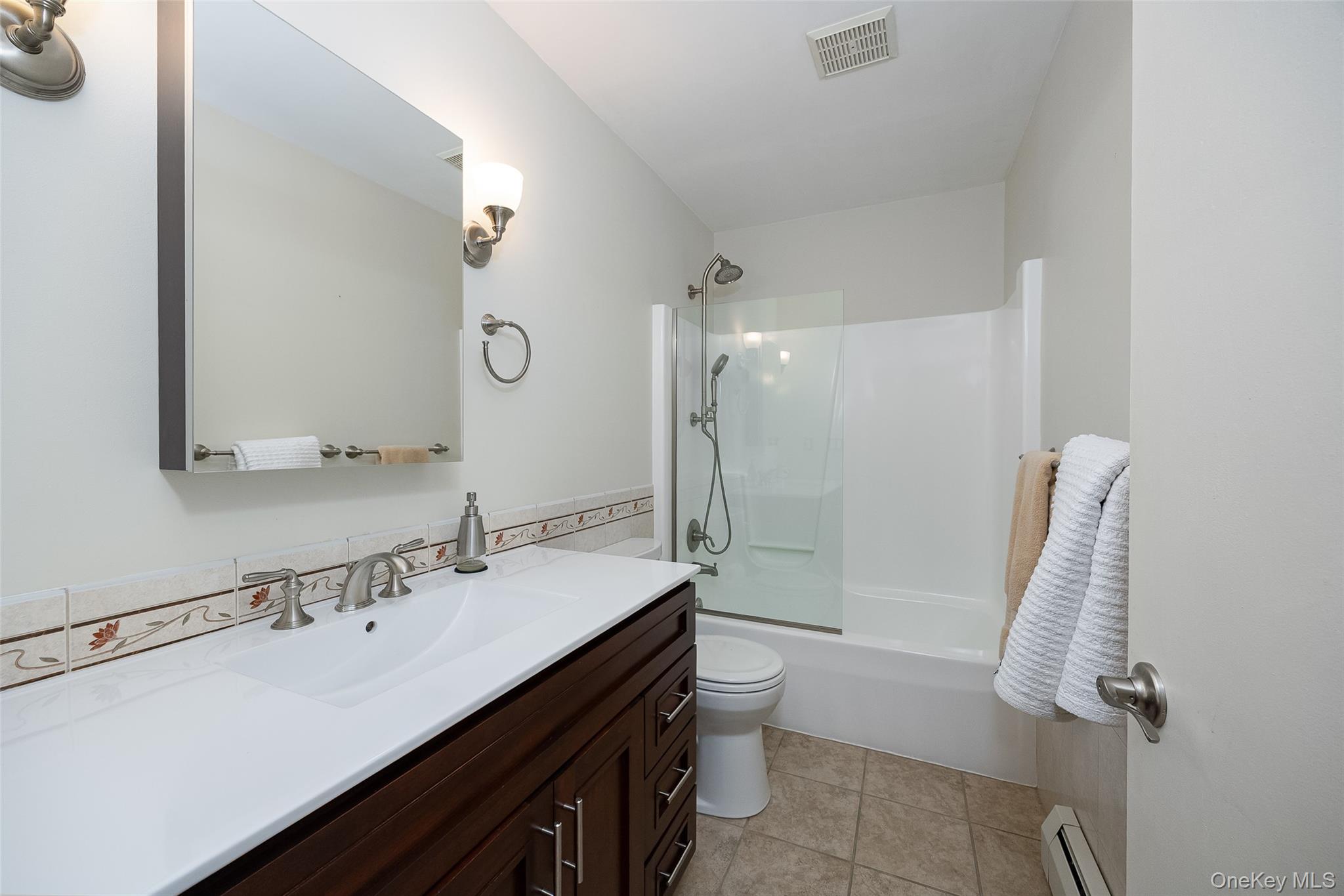 26 St Paul Road Red Hook, NY 12571 - Photo 15 of 35 a bathroom with a sink a toilet a mirror and shower