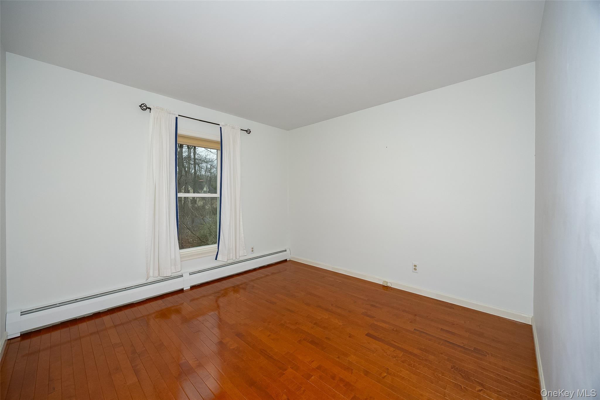 26 St Paul Road Red Hook, NY 12571 - Photo 18 of 35 an empty room with wooden floor and windows