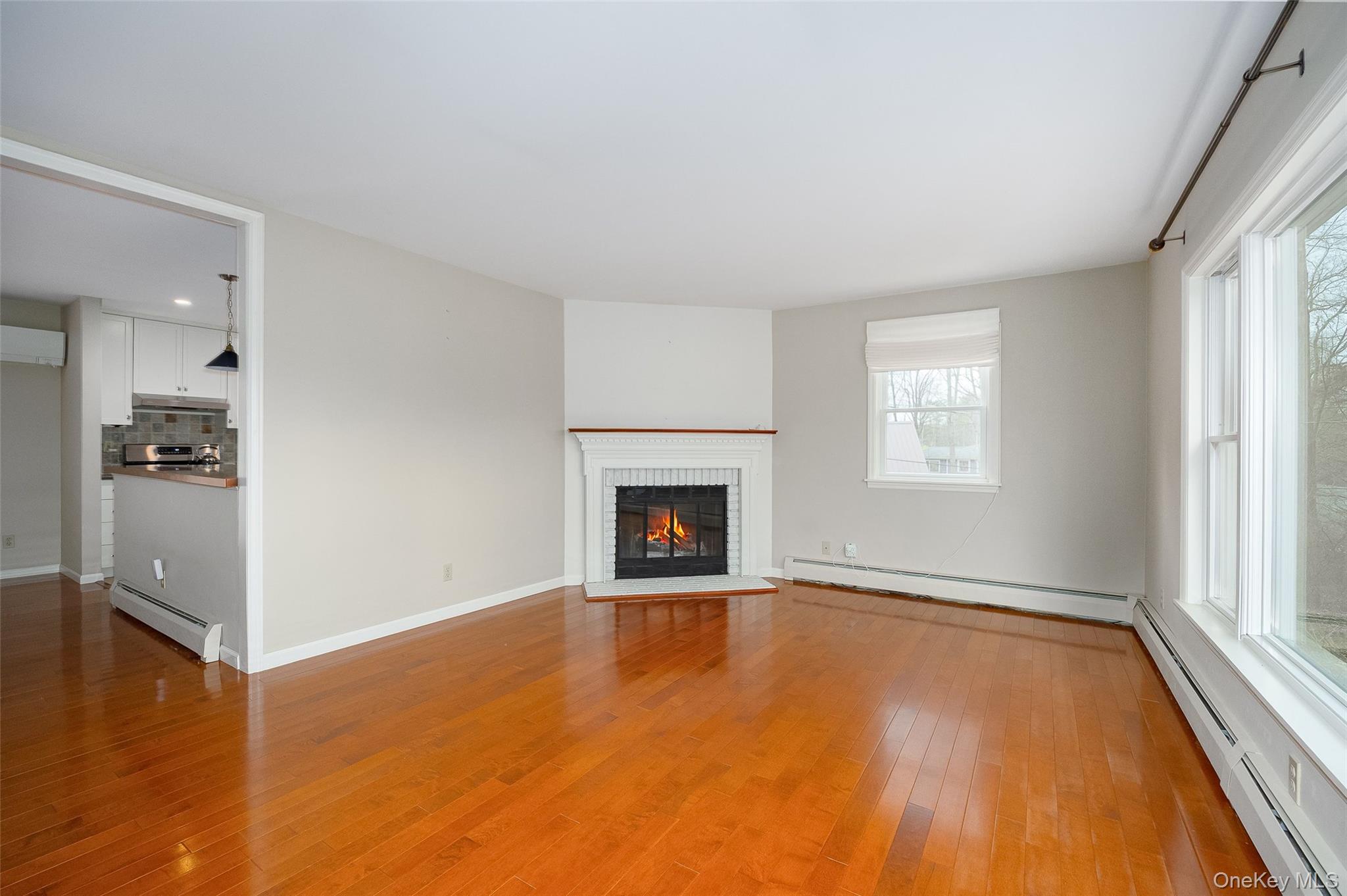 26 St Paul Road Red Hook, NY 12571 - Photo 3 of 35 an empty room with windows and fireplace