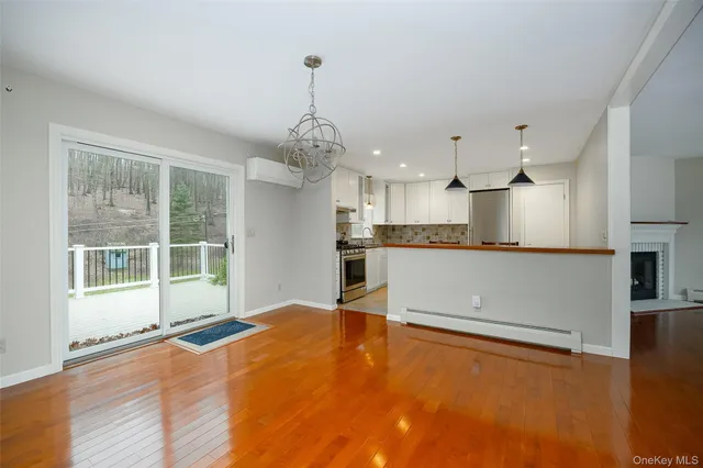 a open kitchen with kitchen island a stove a counter top space and cabinets