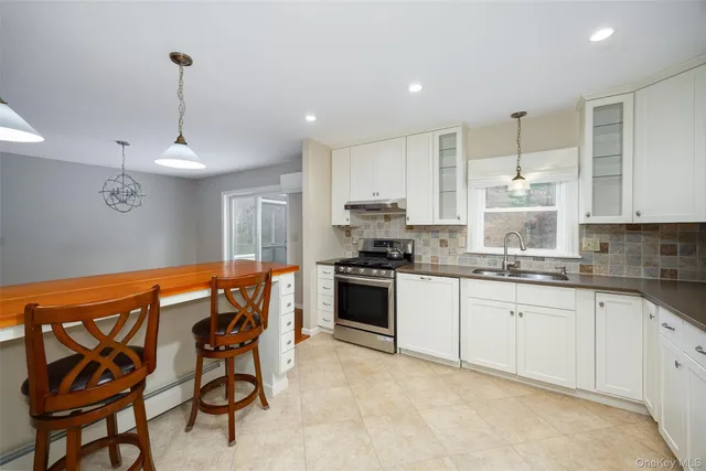 a kitchen with stainless steel appliances kitchen island granite countertop a sink and cabinets