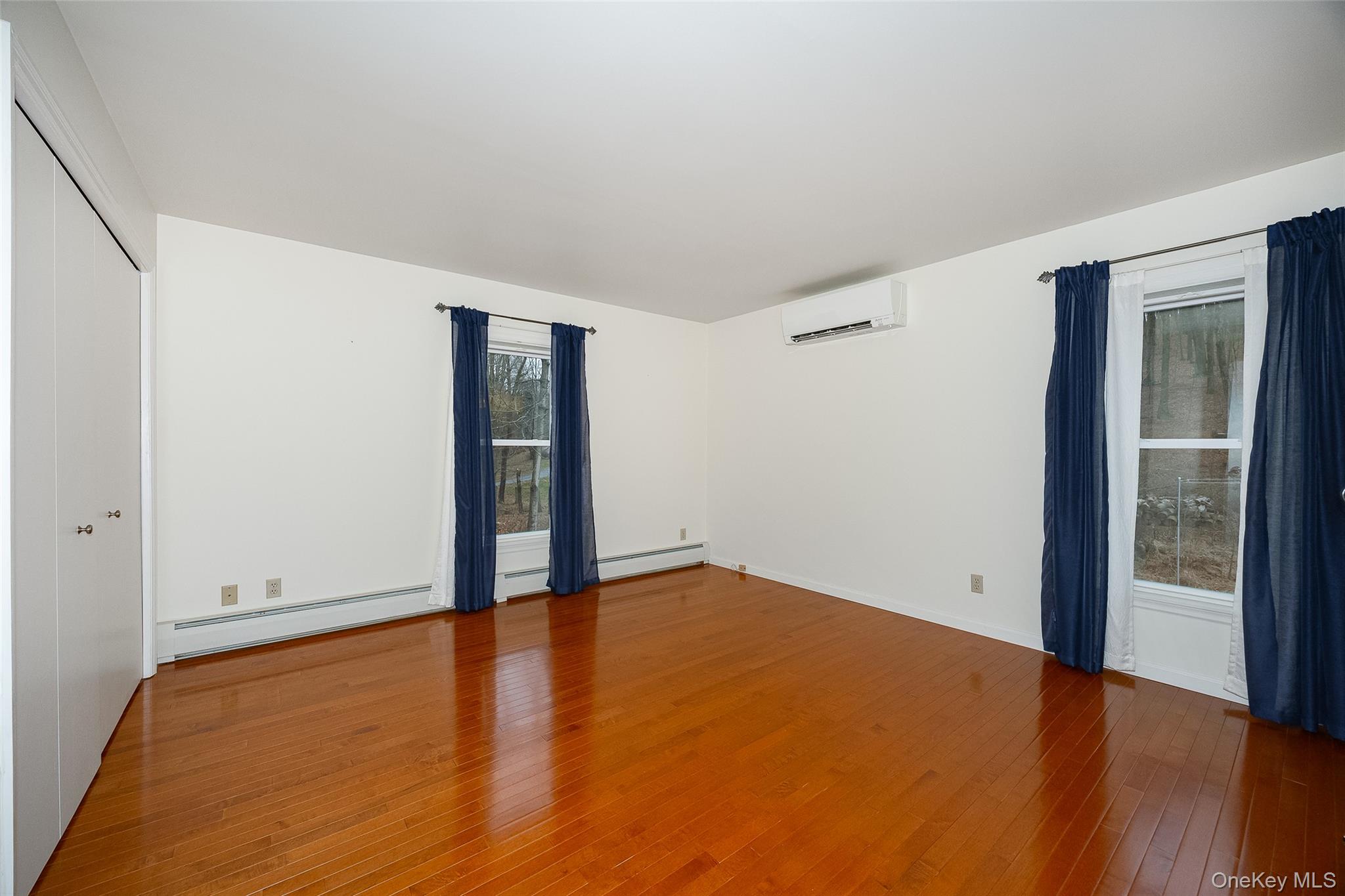 26 St Paul Road Red Hook, NY 12571 - Photo 10 of 35 an empty room with wooden floor and sliding door