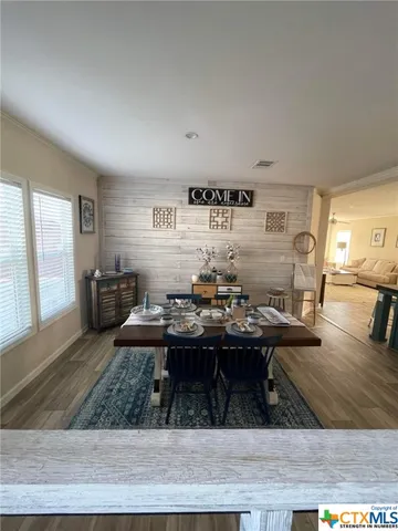 a kitchen with kitchen island granite countertop a sink table and chairs