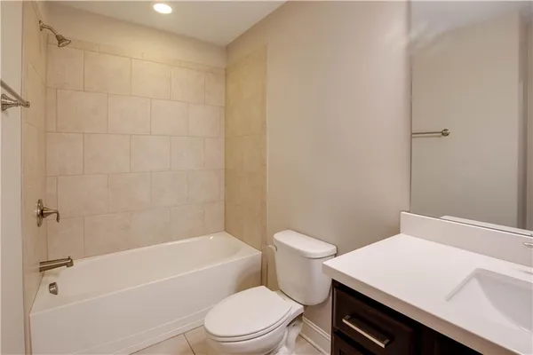 a white toilet sitting next to a bath tub