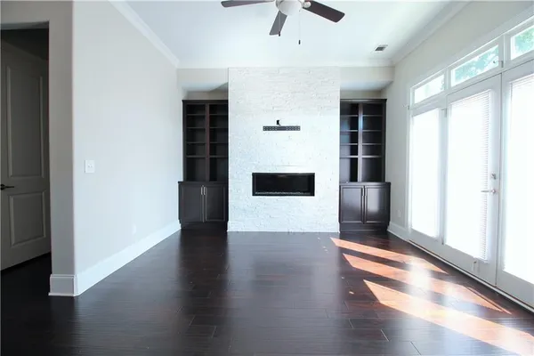 a view of a hallway with wooden floor and a window