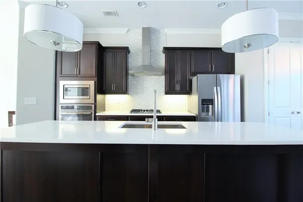 a kitchen with stainless steel appliances a refrigerator and a stove