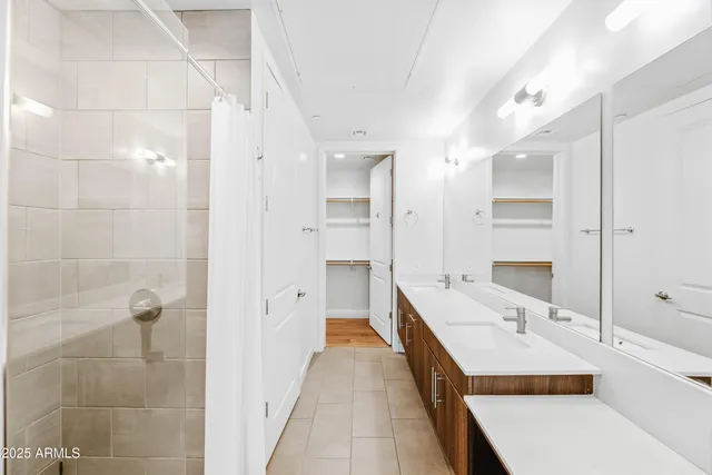 a bathroom with a tub shower and sink