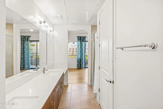 a spacious bathroom with a double vanity sink and a mirror