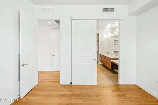 a view of a hallway with wooden floor