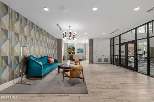 a living room with furniture and a chandelier