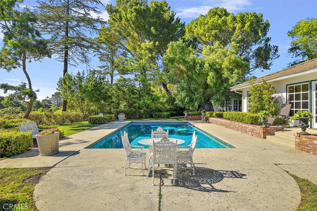 2 Quail Ridge Road South Rolling Hills, CA 90274 - Photo 13 of 67 a view of a swimming pool with a patio and plants