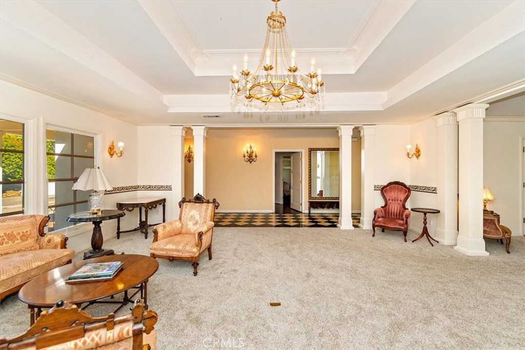 2 Quail Ridge Road South Rolling Hills, CA 90274 - Photo 17 of 67 a living room with furniture a chandelier and a large window