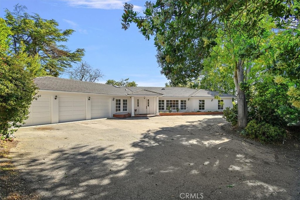2 Quail Ridge Road South Rolling Hills, CA 90274 - Photo 65 of 67 a front view of a house with a garden and trees