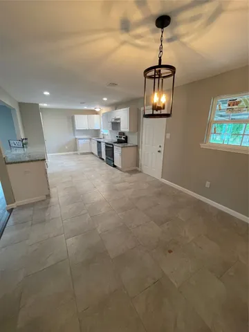 a view of kitchen with granite countertop window and a sink